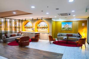 a lobby with two couches and a table and chairs at İstport Hotels in Arnavutköy +59 photos