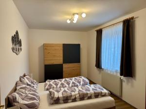 a bedroom with two beds and a window at Ferienhaus am Bauernhof mit Terrasse nähe Wexl Arena in Sankt Corona am Wechsel