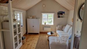a living room with a couch and a table at Lilla huset in Klädesholmen