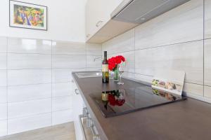 a room with a table with flowers and candles at Apartment Patrik by Rent Istria in Umag