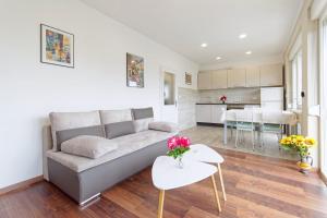 a living room with a couch and a kitchen at Apartment Patrik by Rent Istria in Umag