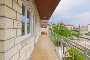 a balcony with a walkway next to a building at Apartment Patrik by Rent Istria in Umag