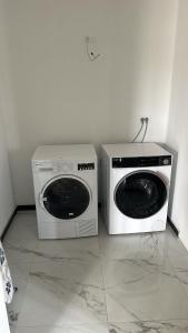 two washing machines sitting next to each other in a room at APARTMANI Sarajevo in SJJ