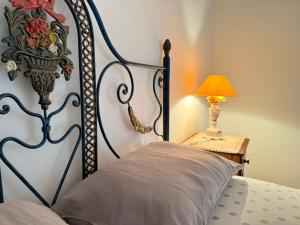 a bedroom with a bed and a lamp on a table at Casa Clara in Castelo de Vide