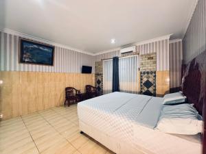 a bedroom with a bed and a chair in it at Hotel Grand Bandara in Medan +37 photos