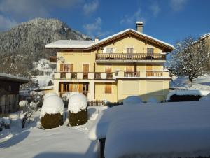 a house with snow on the ground in front of it at Le gîte du Val in Flumet