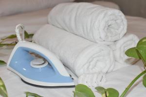 a white towel and a phone on a bed at Ohayo Siargao in General Luna +98 photos