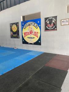 a wall with three wrestling signs on it at HOTEL FÊNIX in Campina Grande