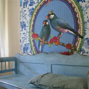 a painting of two birds sitting on top of a bed at Domaine Pyrénées Passions - Gîtes de Charmes & Caractère in Estadens +51 photos
