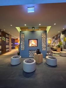 a lobby with a fireplace in the middle of a building at Hotel Hochheide in Willingen