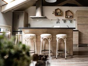 a kitchen with a bar with stools in it at Casa de Tintas in Cuenca