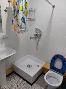 a bathroom with a toilet and a shower and a sink at Uhum Mountain Guesthouse in Yukary-Ukhum