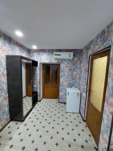 an empty room with a kitchen with a refrigerator at Uhum Mountain Guesthouse in Yukary-Ukhum +9 photos