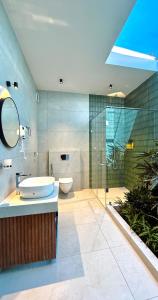 a bathroom with a sink and a toilet and a shower at Flower Valley Plantation Homestay in Munnar +65 photos