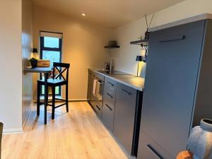 a kitchen with a counter and a table and chairs at Heath Hideaway in Sowerby Bridge +6 photos