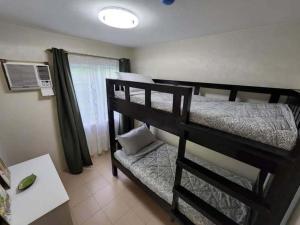 a bedroom with a bunk bed in a room at B2B Condo, MARINA SPATIAL - Dumaguete in Dumaguete +20 photos