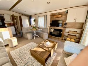 a living room with a couch and a table at The Waterfront in South Cerney +21 photos