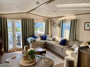 a living room with a couch and a table at The Waterfront in South Cerney