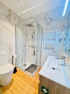 a bathroom with a shower and a toilet and a sink at Bela Vista Studio in Ponta Delgada