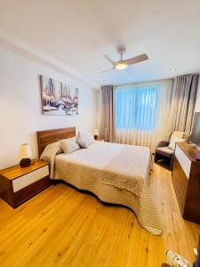 a bedroom with a bed and a ceiling fan at Bela Vista Studio in Ponta Delgada