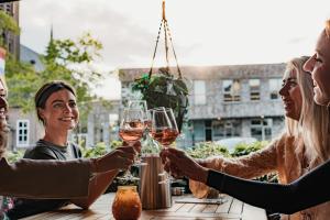 a group of people holding glasses of wine at Herberg d'n brouwer in Zeeland