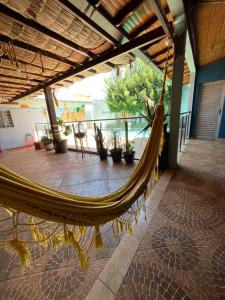 a hammock in a room with a patio at Linda Casa com Piscina e Edícula Gourmet Ouro verde in Foz do Iguaçu