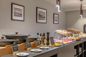 a buffet line with pastries and other food items at NH Bariloche Edelweiss in San Carlos de Bariloche