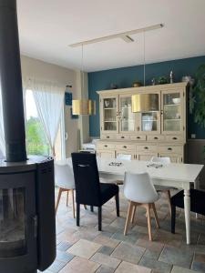 a dining room with a fireplace and a table and chairs at Le clos mirélie in Gaujac