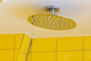 a yellow light on the ceiling of a bathroom at De Bossche Kraan in Den Bosch