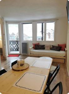 a living room with a couch and a table at Jonquille 5 personnes in Chamonix