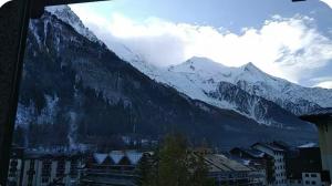 a view of a snow covered mountain with a city at Jonquille 5 personnes in Chamonix