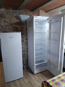a white refrigerator with its door open in a room at L'alberg la rectoria de la Torra in La Baronia de Rialb