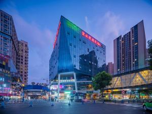 a tall glass building in a city at night at Ibis Chengdu High-tech Electronics University in Pi