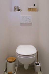 a bathroom with a white toilet in a room at Maison Bonheur in Bruges +3 photos