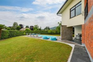 a backyard with a swimming pool and a house at Aurora Villa in Lesa