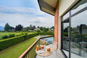 a balcony with a table and chairs on it at Aurora Villa in Lesa