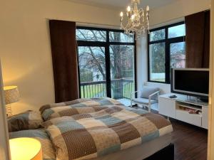 a bedroom with a bed and a tv and windows at Aurora Villa in Lesa +31 photos