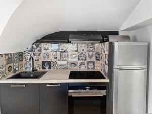 a kitchen with a sink and a stove top oven at Maison rénovée avec terrasse et parking privé in Mallemort