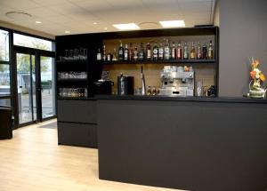 a bar with a coffee maker on top of it at The Originals City, Hôtel Hélios, Roanne Nord in Mably
