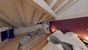 a large room with a large bed in a attic at Chalet Chavanette - Beautiful 7 bedrooms Chalet in Champéry