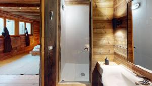 a bathroom with a shower and a white sink at Chalet Chavanette - Beautiful 7 bedrooms Chalet in Champéry +23 photos