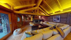 a large living room with a couch and a fireplace at Chalet Chavanette - Beautiful 7 bedrooms Chalet in Champéry