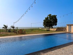 a swimming pool with a view of the beach at Atarah Beach Hotel in Negombo