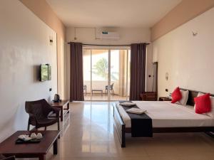 a hotel room with a bed and a table at Atarah Beach Hotel in Negombo