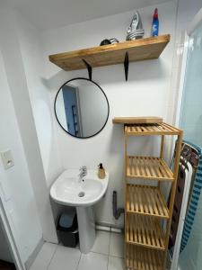 a bathroom with a sink and a mirror at Maison proche Naval Group in Lanester