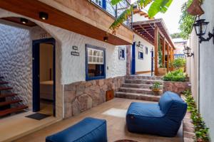 a patio with blue chairs in front of a building at Villa Hortensia in Mucugê