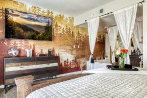 a bedroom with a painting on the wall at 2 King BRs Balcony Resort Amenities Free Tix in Pigeon Forge