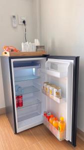 a refrigerator with its door open with food inside at สังข์เงินรีสอร์ท2 in Nakhon Sawan