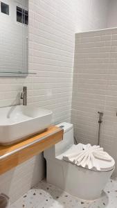 a white bathroom with a sink and a toilet at สังข์เงินรีสอร์ท2 in Nakhon Sawan +27 photos