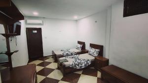 a living room with two chairs and a table at Hostel le Coin d'Or in Fort de lʼEau +17 photos
